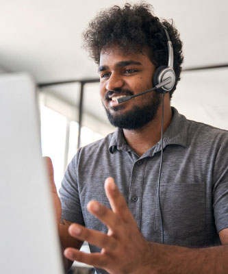 Contact Us image of employee in gray shirt wearing headset